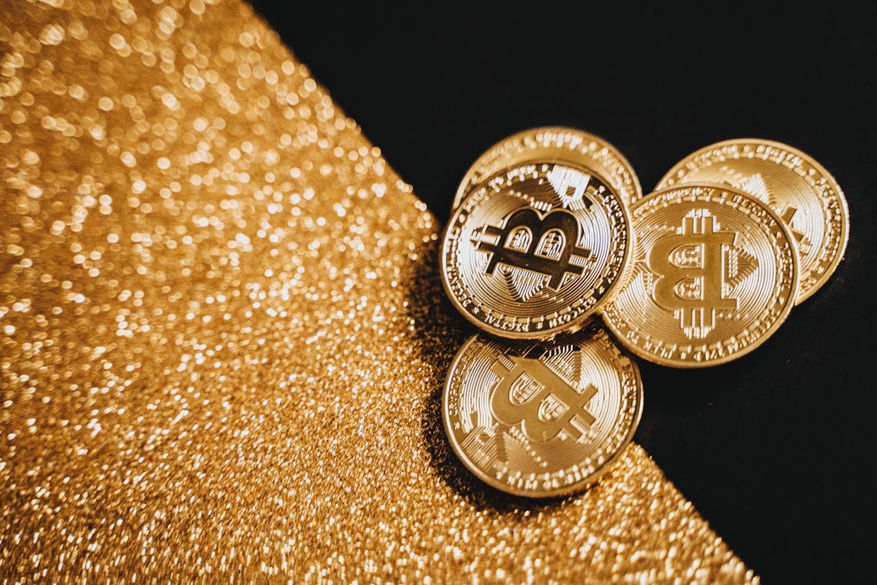 how-it-works Gold Bitcoin coins displayed on a sparkling gold texture, representing digital currency and finance.